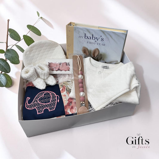 boxed baby gift with baby cap, sweater, book booties pacifier clip and blankie