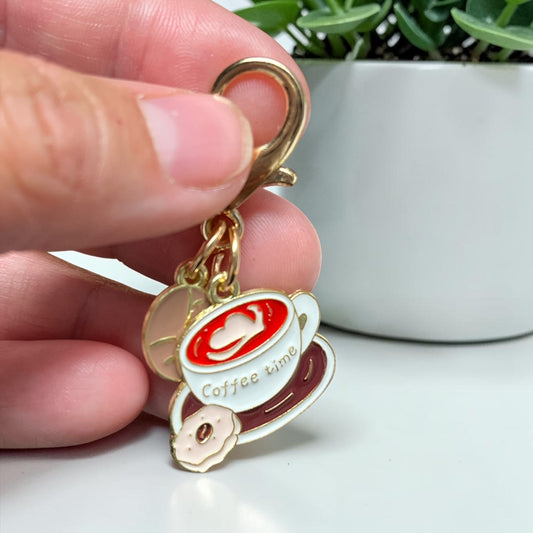 Pocket hug Keychain with a coffee-themed design on a card, placed on a wooden surface, unique keychain, pocket hug in Windsor Ontario. unique gift