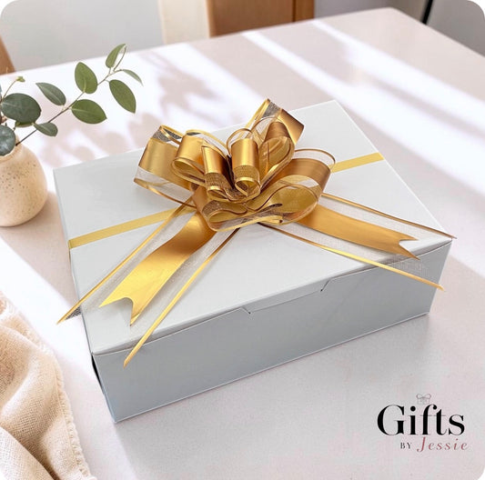 showing a white boxed gift with gold bow