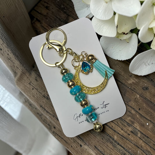 handmade teal glass bead keychain with gold moon charm and teal tassel