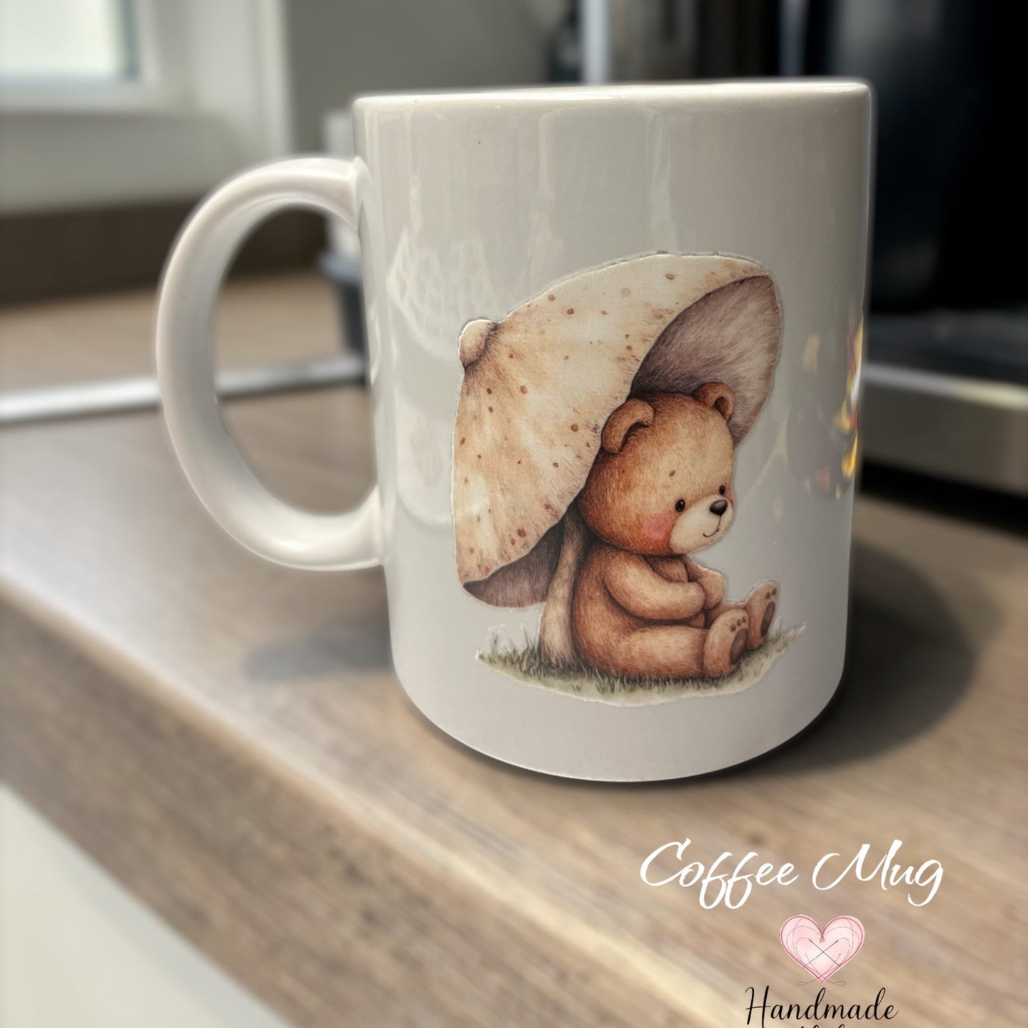 white ceramic mug with a teddy bear holding a mushroom umbrella