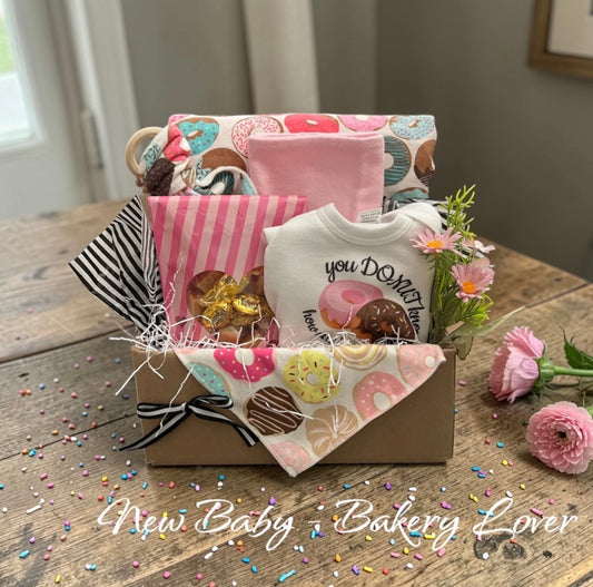 Bakery-themed baby gift basket with handmade flannel minky blanket, onesie, wood teether, and keepsake flowers — handmade in Windsor, Ontario