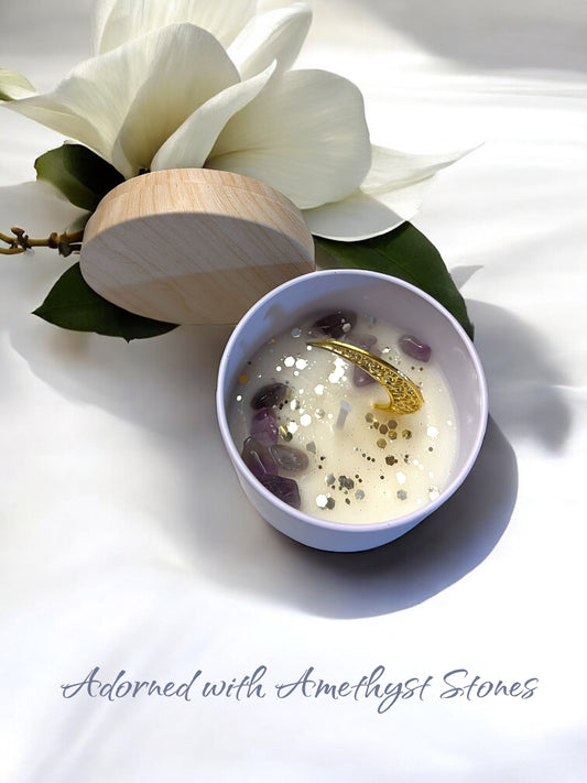 Candle in a white bowl with a wooden lid, surrounded by white flowers on a light background, with 'Mystical Moon' text. handmade unique candle with keepsake moon necklace pendant made in canada