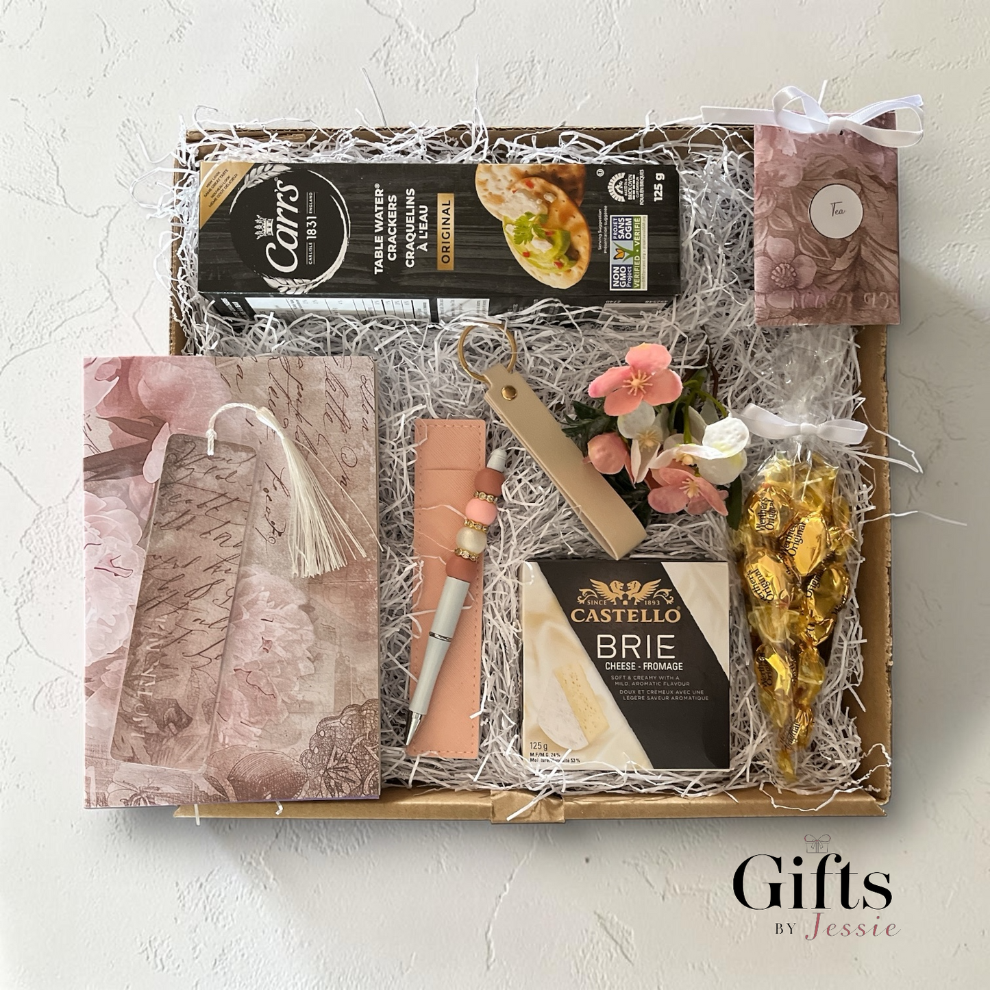 unique gift box with cheese, crackers, candy, tea a puzzle book, handmade pen 