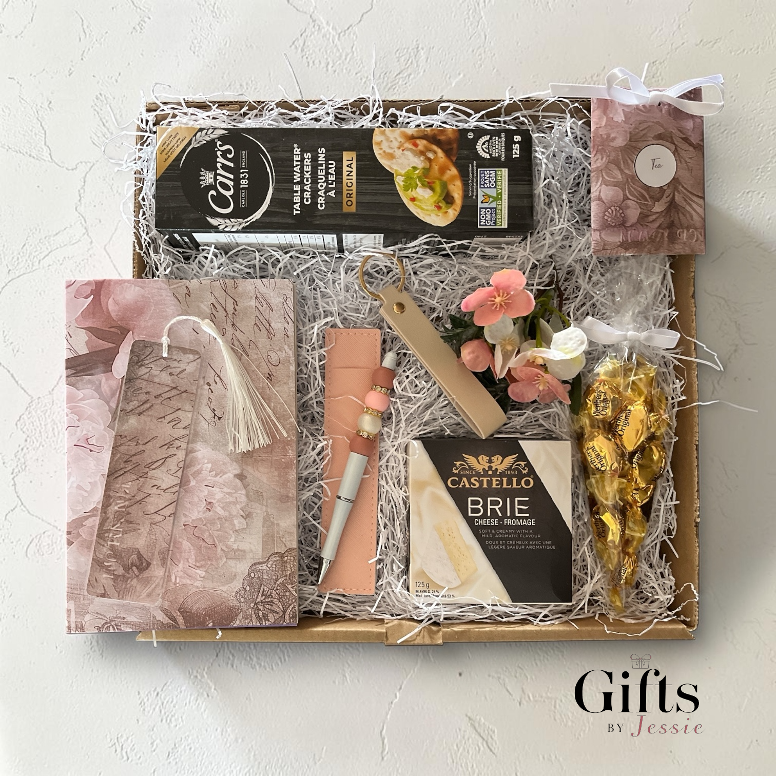 unique gift box with cheese, crackers, candy, tea a puzzle book, handmade pen 