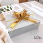 showing a white boxed gift with  gold bow