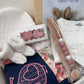 boxed baby gift with baby cap, sweater, book booties pacifier clip and blankie