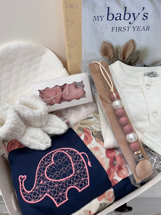 boxed baby gift with baby cap, sweater, book booties pacifier clip and blankie