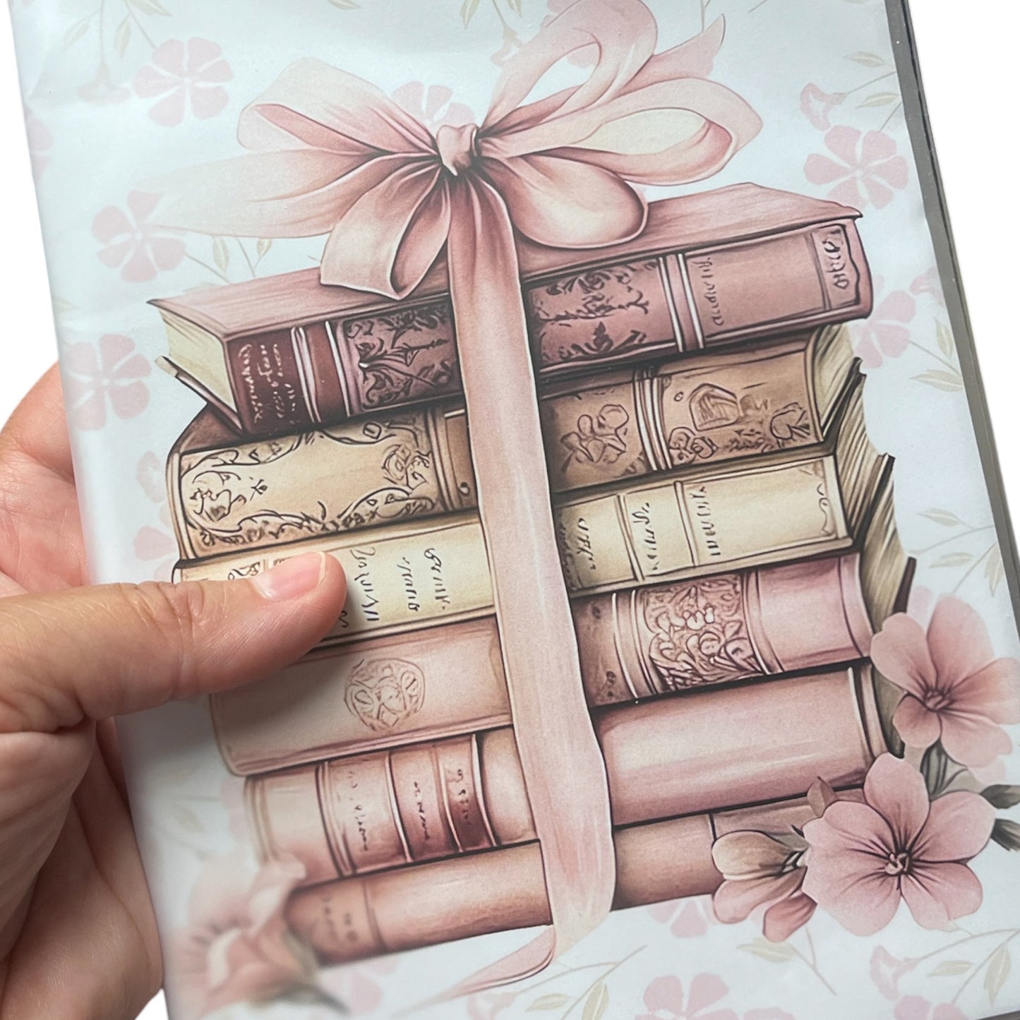 Notebook with clear plastic cover pink stacked books with a pink bow graphic on the front of the notebook