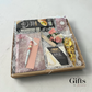 unique gift box with cheese, crackers, candy, tea a puzzle book, handmade pen