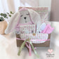 pink baby items in a gift basket
