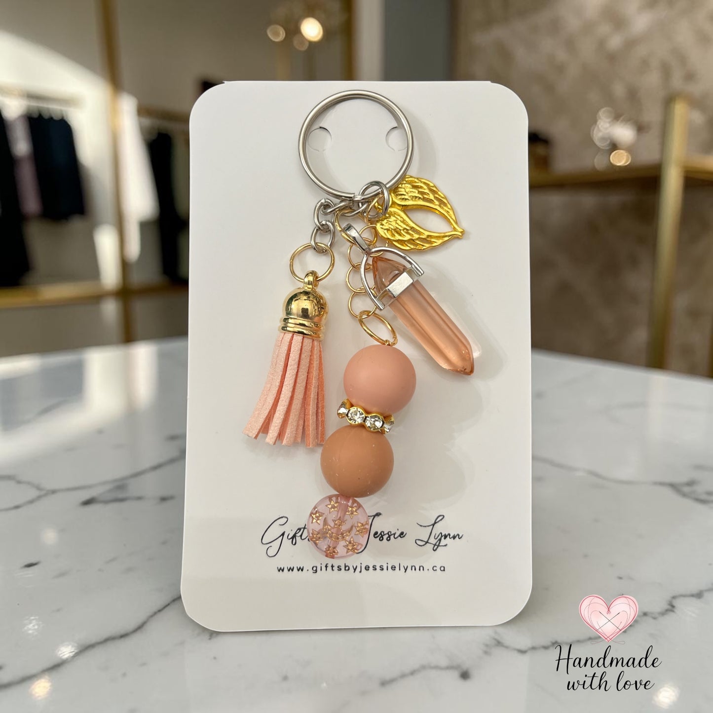 blush color beaded keychain with gold angel wings
